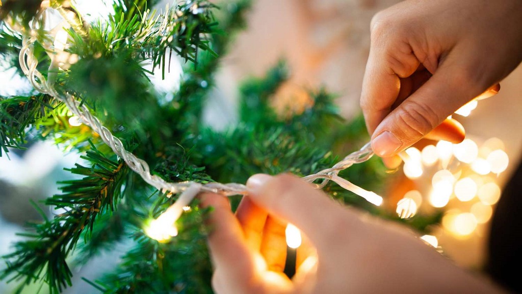 Stringing the Lights to Decorate a Christmas Tree