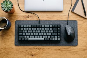 Budget ergonomic vertical mouse on a wooden desk setup.