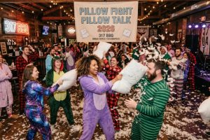 Guests in pajamas enjoying Pillow Fight Pillow Talk 2026 event at 317 BBQ Broad Ripple Indianapolis